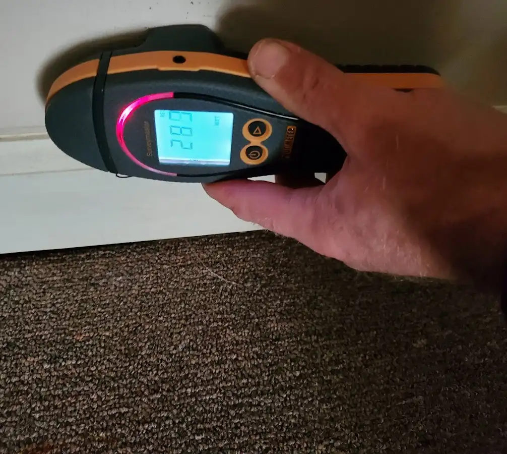 Moisture detection at baseboard during Storm Damage Restoration in Chicago Ridge